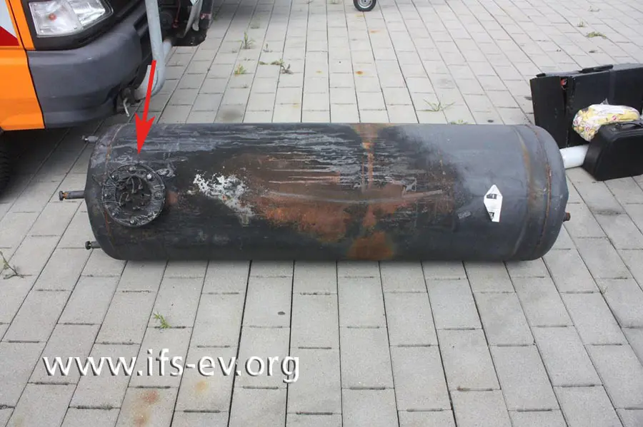Rechts des Heizflansches, den wir hier mit einem Pfeil markiert haben, sind die stärksten Brandschäden am Gehäuse des Warmwasserspeichers zu erkennen.