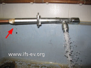 Bei der Dichtigkeitsprüfung tritt an der Gewindeverbindung von Ventilrohr und Anschluss-Stück Wasser aus (Pfeil).